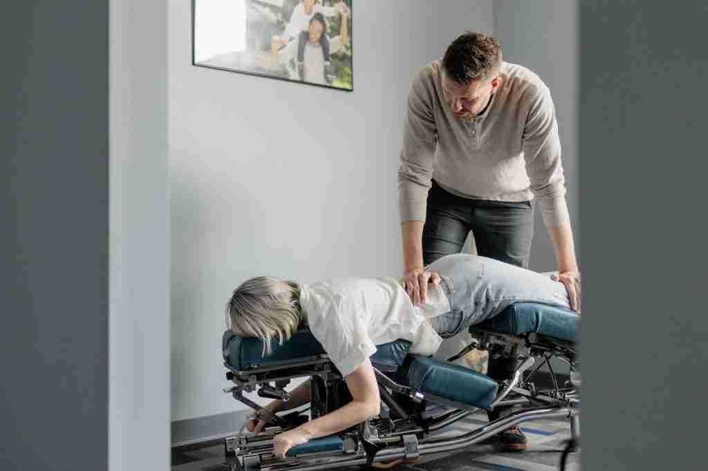 A man and woman engage in a physical therapy session to improve strength and mobility